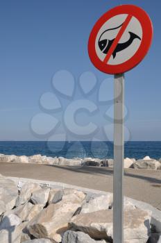 Royalty Free Photo of a No Fishing Sign on a Pier