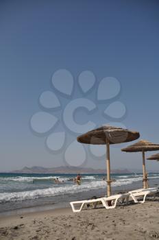 Royalty Free Photo of a Beach With an Umbrella and Chairs in Kos, Greece 