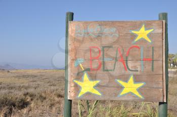 Royalty Free Photo of a Beach Wooden Sign at Kos Island, Greece 