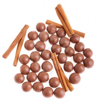 Royalty Free Photo of Chocolate Coated Almonds and Cinnamon Sticks 