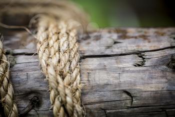 Closeup of rope tied around wood pole