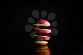 fresh apple in pieces on a black background
