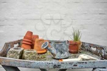 old gardening tools on a table in a garden