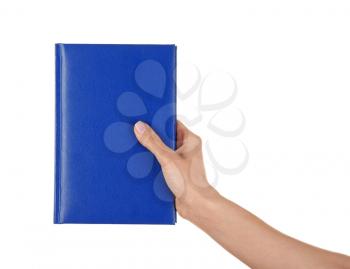 Female hand holding book with blank cover on white background�