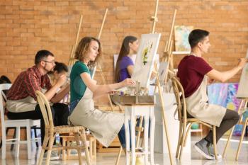 Group of people during classes in school of painters�