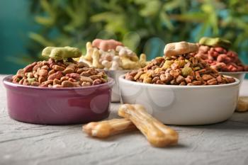 Bowls with pet food on table�
