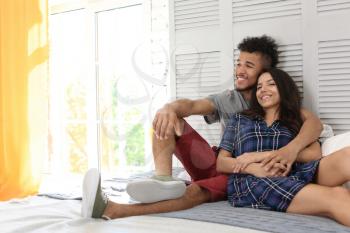 Happy African-American couple at home�