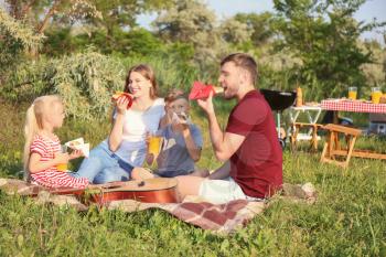 Happy family having lunch on summer picnic�