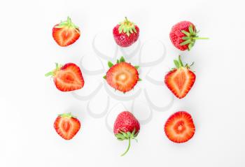 Flat lay composition with ripe strawberries on white background�