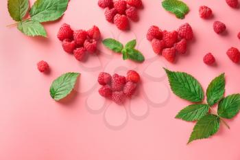 Composition with ripe aromatic raspberries on color background�