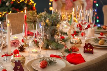 Stylish table setting with burning candles and Christmas decorations�