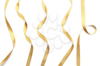 Golden satin ribbons on white background�