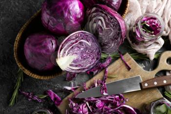 Composition with cut red cabbage on grunge table�