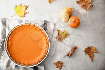 Baking dish with tasty pumpkin pie on table, top view�