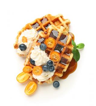 Tasty waffles with fruit, berries and cream on white background�