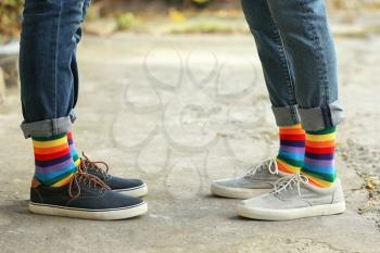 Gay couple with colorful socks outdoors�