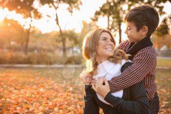 Happy mother and son in autumn park�