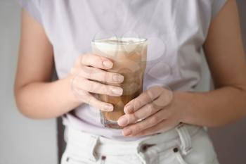 Woman drinking tasty cold coffee, closeup�