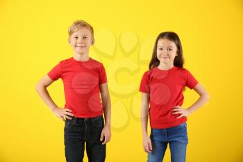 Cute children in t-shirts on color background�