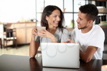 Young couple with laptop at home�