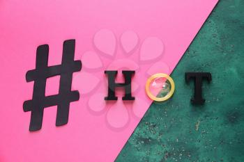 Creative composition with hashtag HOT on color background�
