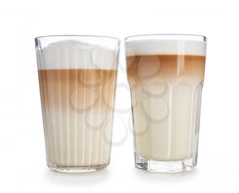 Glasses of tasty aromatic latte on white background�