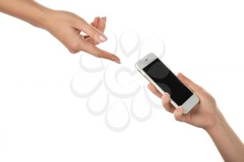Female hands passing mobile phone on white background�