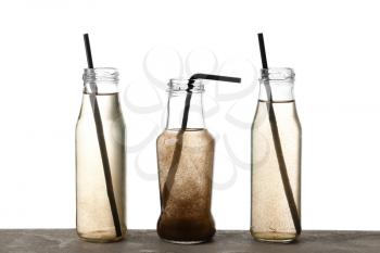 Bottles of dirty water on white background�