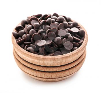 Wooden bowl with delicious dark chocolate chips on white background�