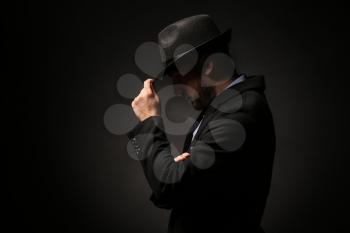 Portrait of detective on dark background�