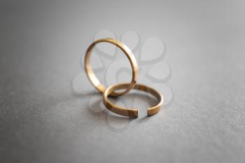 Whole and broken rings on grey background. Concept of divorce�