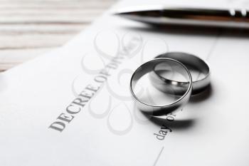Rings with decree of divorce on table, closeup�