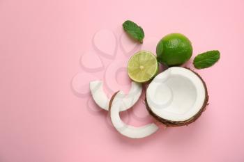Ripe coconut and lime on color background�