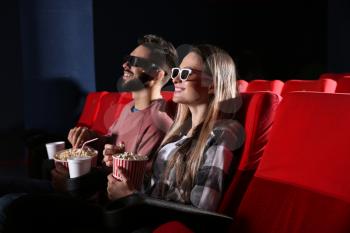 Young couple watching movie in cinema�