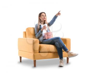 Young woman with popcorn watching movie on white background�