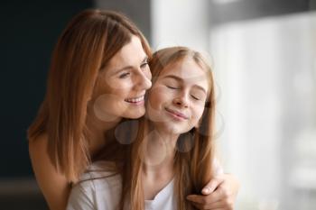 Portrait of happy mother and daughter near window�