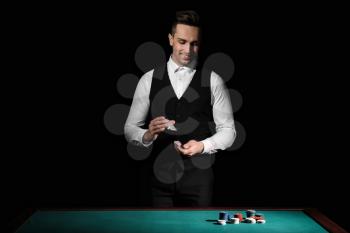 Handsome male banker at table in casino�