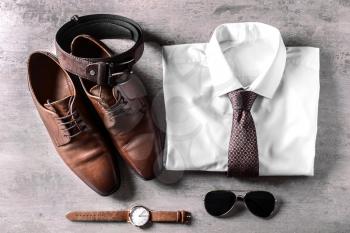 Stylish male clothes and accessories on wooden background�