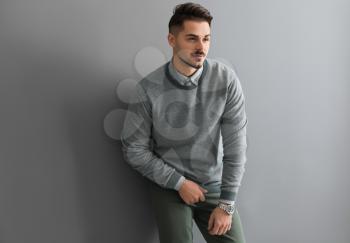 Stylish handsome man on grey background�