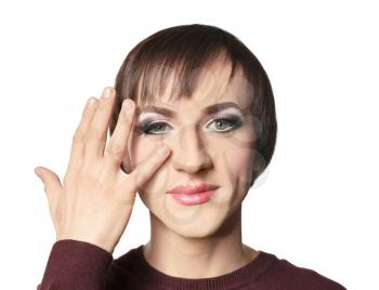 Portrait of transgender man with bright makeup on white background�