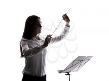 Silhouette of young orchestral conductor on white background�