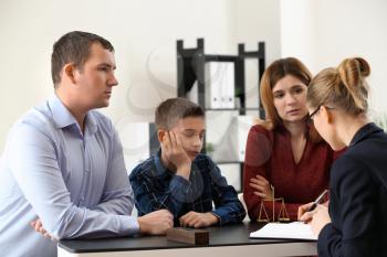 Divorced parents with their son visiting lawyer. Concept of child support�