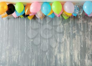 Many colorful balloons under ceiling in room�