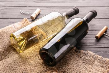 Bottles of tasty wine on wooden table�