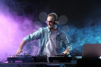 Male DJ playing music in club�