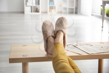 Young woman in slippers resting at home�