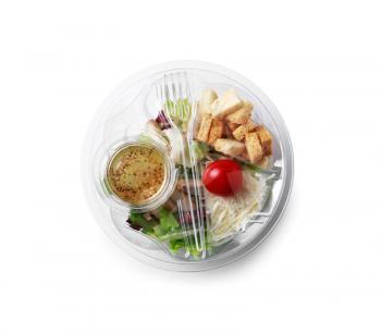 Container with delicious food for delivery on white background�