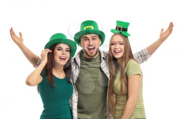 Young people in green hats on white background. St. Patrick's Day celebration�