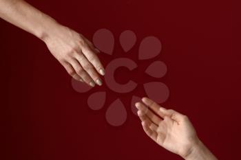 Female hands reaching out to each other on color background. Stop a suicide�