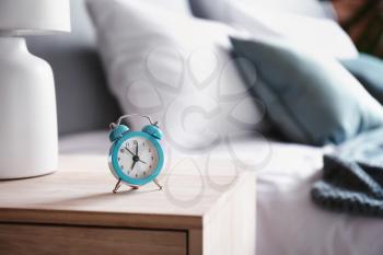 Alarm clock on table in bedroom�